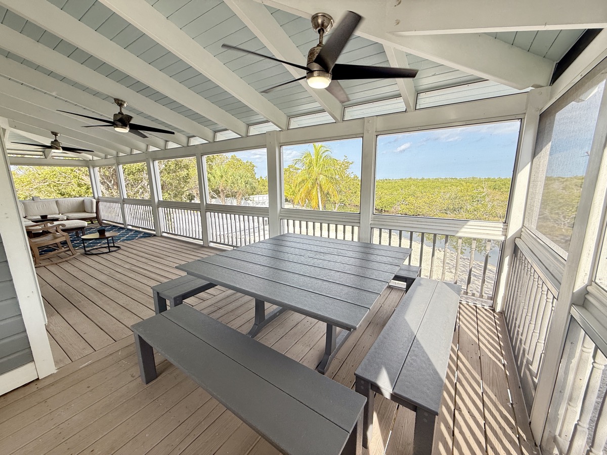 Screened porch with dining and lounge areas